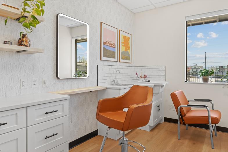 Private salon suite with chairs and natural light