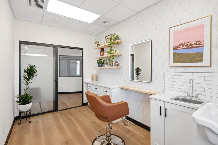 Private salon suite with mirror and styling chair